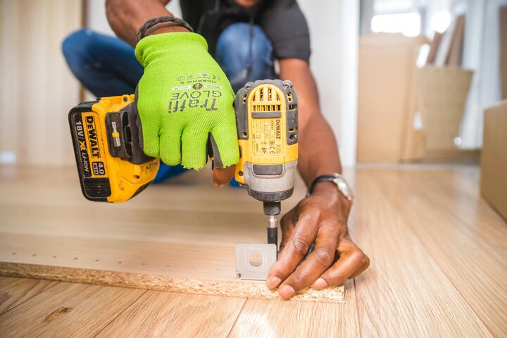 man using yellow drill 