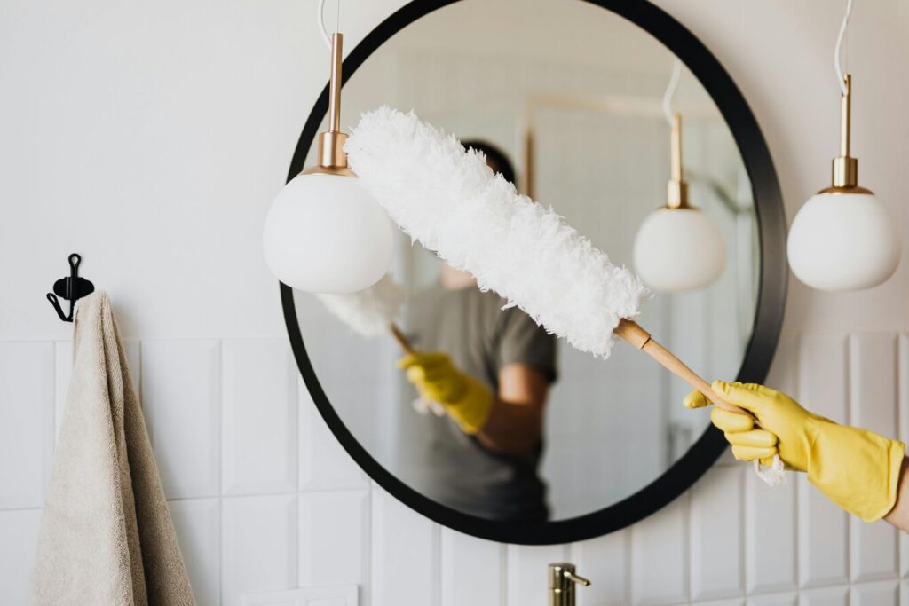 person using feather duster   